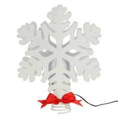 a white snowflake with a red bow hanging from it's centerpiece