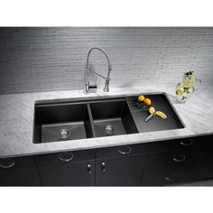 an image of a kitchen sink with granite counter top and black cabinets in the background