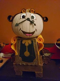 a pumpkin shaped like a bear with a clock on it's face and arms