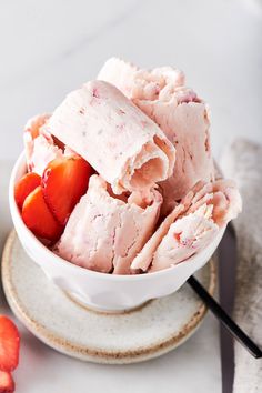 a white bowl filled with ice cream and strawberries