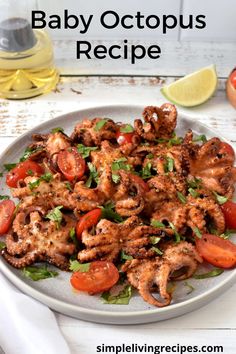 a white plate topped with octopus and tomatoes