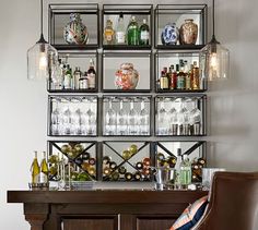 a bar with wine glasses and liquor bottles on the shelves, along with a leather chair