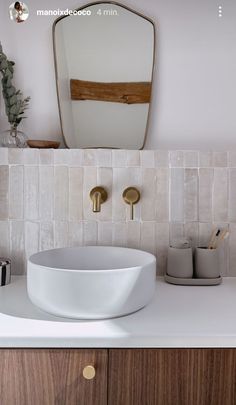 a bathroom sink sitting on top of a white counter