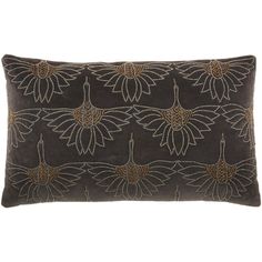 a black and gold embroidered pillow with large flowers on the front, sitting on a white background