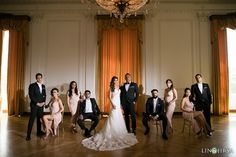 a group of people in formal wear posing for a photo