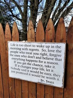 a wooden fence with a sign that says life is too short to wake up in the morning