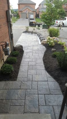 a brick walkway in front of a house