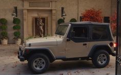 a jeep is parked in front of a house