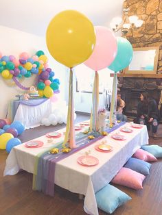 a table with balloons and plates on it