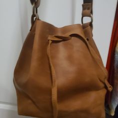 I Bought This Purse On Etsy It's Handmaid. It's Never Been Used It's Just Doesn't Really Go With My Stuff. A Nineties Style . Love The Natural Leather But I Just Don't Have Stuff That Goes With That It's Such A Nice Quality Purse. It's Not Treated So It Will Get That Awesome,Lived In Look To It As You Use It. It Would Get The Good Kind Of Marks On It. Or You Could Treat It If You Want To. Very Natural Looking. Nice Size Plenty Of Room. Has That 90s Style To It. The Last Picture Is Quite Close Up Casual Camel Hobo Bag With Adjustable Strap, Casual Camel Soft Leather Shoulder Bag, Casual Soft Leather Camel Shoulder Bag, Camel Bucket Bag For Travel, Casual Camel Leather Shoulder Bag, Everyday Light Brown Bucket Hobo Bag, Casual Camel Bag For Errands, Camel Everyday Bucket Shoulder Bag, Camel Leather Hobo Bag With Adjustable Strap