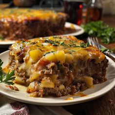 there is a piece of meat and cheese casserole on the plate next to it