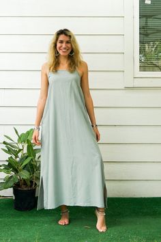 Embrace the bohemian spirit with the Natural Cotton Boho Dress with Pockets. This handmade dress combines comfort, style, and practicality, making it a perfect addition to your wardrobe. With features like adjustable tie-back straps and side pockets, this dress is ideal for any casual occasion. Key Features ‣ Handmade Quality: Each dress is carefully crafted to ensure high quality and durability. ‣ Bohemian Style: Embrace a relaxed, bohemian look with this stylish and comfortable dress. ‣ Functi Green Maxi Dress With Side Slits For Beach, Bohemian Sleeveless Dress With Side Slits, Bohemian Dresses With Side Slits For Spring, Sage Dresses For Summer Beach, Flowy Sage Casual Dress, Bohemian Beach Dresses With Side Slits, Bohemian Flowy Dress With Side Slits, Flowy Bohemian Dresses With Side Slits, Bohemian Maxi Dress With Side Slits For Summer