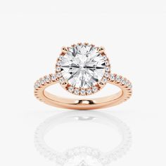 a rose gold engagement ring with an oval cut diamond in the center