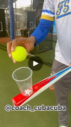 a man holding a tennis ball and racquet