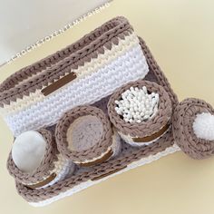 a crocheted purse with three small items in it