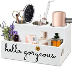 a white box filled with lots of beauty products and hairbrushes on top of each other