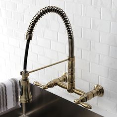 a faucet that is attached to a sink in a room with white brick walls