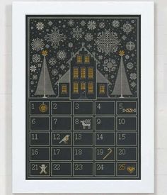 a cross stitch calendar with houses and snowflakes in the background, on a white frame