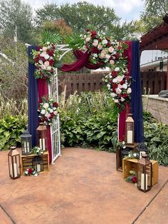 an outdoor wedding setup with flowers and candles