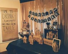 there is a table set up with drinks and decorations for a drink tasting at home