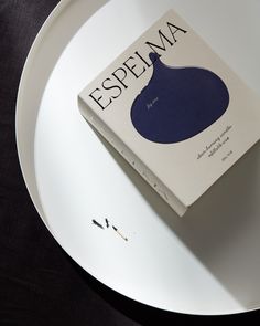 a book sitting on top of a white plate