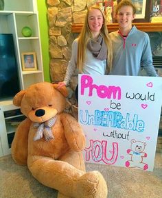 two girls standing next to a large teddy bear holding a sign that says prom would be unbreakable without you