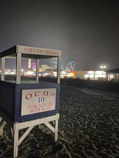 a small stand on the beach at night