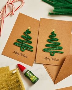 three christmas cards with the words merry christmas written on them next to some candy canes