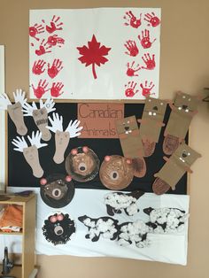 a bulletin board with handprints and canadian animals