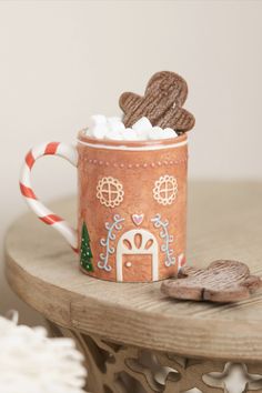 Get into the holiday spirit with our Gingerbread House Ceramic Mug. Featuring a charming gingerbread house design, this festive mug is perfect for enjoying your favorite seasonal beverages. Whether you're sipping hot cocoa, coffee, or tea, this delightful mug adds a touch of holiday cheer to your everyday routine. Hot Cocoa Coffee, House Ceramic, Gingerbread House Designs, Cocoa Coffee, Baby Bubble Romper, Baby Bubble, Everyday Routine, Diy Pottery, Holiday Christmas Gifts