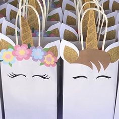 these unicorn bags are decorated with gold glitter and flower crowns on their ears, as if they were for a birthday party