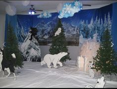 an indoor winter scene with polar bears and trees