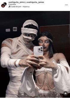 a man and woman dressed in white are taking a selfie with their cell phone