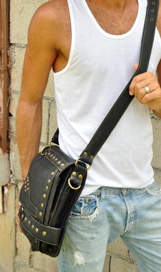 "Guys, you need this stylish shoulder bag for essentials, like your notebook or mini laptop devices, your phone, journal, wallet and keys. And, ladies, you already know how beneficial crossbody handbags are and this one is hard-core, smokin' biker bad. Oversized brass nailhead studs and an edgy geometric design make this an artistic statement that'll enhance even a basic, solid color t-shirt. Functional and secure, this hip bag features 2 exterior zipper compartments, 1 interior zipper compartme Phone Journal, Brown Leather Messenger Bag, Stylish Leather Bags, Sling Bag For Men, Mini Laptop, Leather Hip Bag, Leather Sling Bag, Studded Bag, Leather Laptop Bag