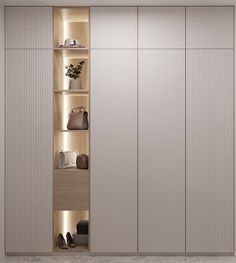 an empty closet with several shelves and shoes on the floor, in front of a white wall