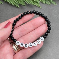 BREATHE Acrylic Bead Bracelet - the perfect mix of style and motivation, this bracelet features a simple yet inspiring design to remind you to take a moment to breathe. Available in a variety of colors, choose the one that speaks to you. The custom made bracelet has 6mm acrylic beads and flat white acrylic letter beads, which are 7mm diameter. It is thread on strong elastic and will stretch a little bit so you can roll it onto your wrist gently. Allergy friendly, lightweight and super comfortable to wear! Comes in more than 20 gorgeous colour options and 12 sizes up to 4XL, so you will always find one that fits! Inspirational Beaded Bracelets For Everyday, Inspirational Adjustable Hypoallergenic Beaded Bracelets, Inspirational Hypoallergenic Stretch Bracelet For Everyday, Casual Bracelets With 8mm Beads For Meditation, Casual Bracelets For Meditation With 8mm Beads, Inspirational Hypoallergenic Stretch Bracelet With Round Beads, Casual 8mm Beaded Bracelets For Meditation, Meaningful Stretch Bracelet With Round Beads For Friendship, Adjustable Inspirational Bracelets With 8mm Beads