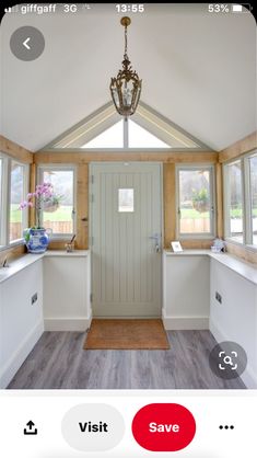 the inside of a house with french doors and windows in it's center area