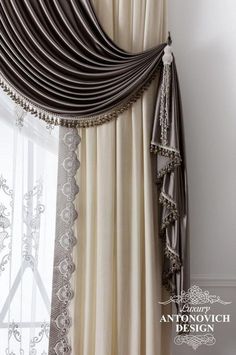 an elegant curtain with beaded trim hanging on the side of a window sill