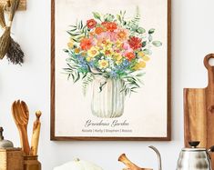 an arrangement of flowers in a vase is displayed on the wall next to other kitchen utensils