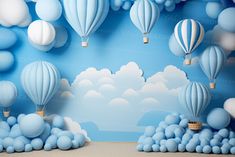 blue and white hot air balloons floating in the sky with clouds behind them on a wall