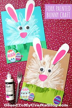 some bunny crafts that are on top of a red table cloth with paint and paper