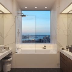 a bath room with a tub a sink and a large window overlooking the cityscape