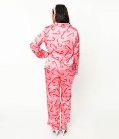 Snuggle up in sweet dreams! Made from smooth pink satin and adorned with delightful candy cane prints throughout, these pajamas will transport you to a cozy winter wonderland. The top features long sleeves, a classic collar neckline, a convenient button-up front, and even handy pockets for that midnight snack stash. The bottoms boast an elastic band for the perfect fit and come complete with a self-tie for added comfort. Whether you're lounging around the house or indulging in some well-deserved Snack Stash, Pink Candy Cane, Satin Pajama Set, Midnight Snack, Satin Pajama, Satin Pyjama Set, Satin Pajamas, Cozy Winter, Pink Candy