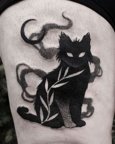 a black cat tattoo on the thigh