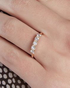 a woman's hand with a diamond ring on it