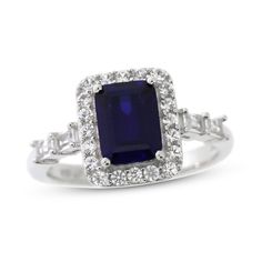 an engagement ring with a blue stone surrounded by diamonds