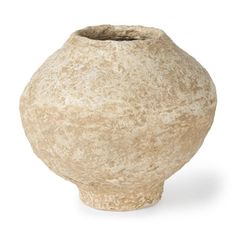 a large stone vase sitting on top of a white surface