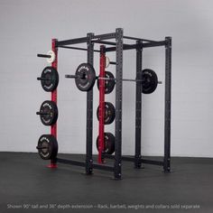 a squat rack with four barbells and two sets of weight plates