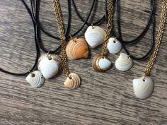 All natural seashell necklaces, handmade with beautiful, pristine shells collected along the Atlantic coast.  Available in multiple colors and chain/string types. Choose from multiple available shell colors: -white -purple gradient -grey -sunset orange -white/brown -golden shimmer* All shell types available with either a metal chain or black string necklace.  Please allow for natural variations in exact shape, color and size.  * golden shimmer option is a natural white shell with a light man mad White Shell Charm Necklaces, Shell Charm Necklace As A Gift, Shell Charm Necklaces As Gift, Shell Shape Charm Necklace As A Gift, Black String Necklace, Shell Types, Grey Sunset, Seashell Necklaces, Tropical Nature