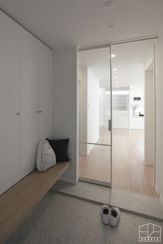 a pair of slippers sitting on top of a wooden floor next to a closet